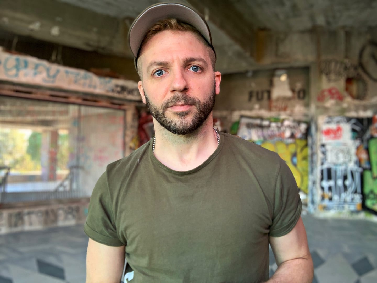 Image of Artist in Residence, Blake Pfeil, standing in an abandoned building.