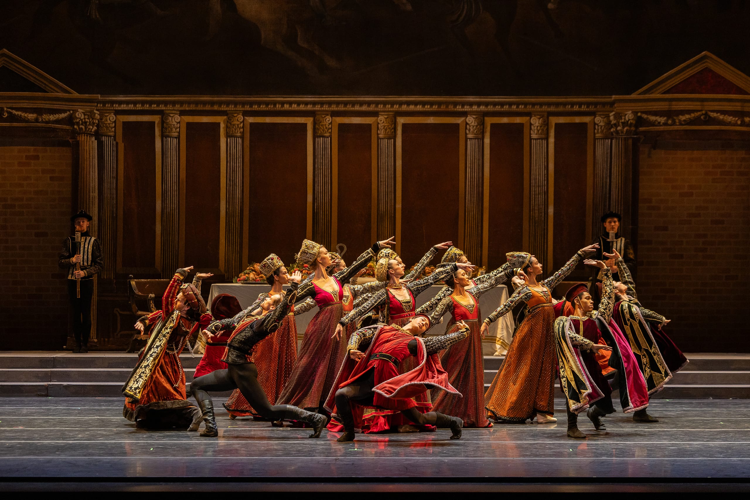 A group of ballet dancers onstage holding a pose